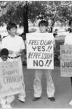 Chinese Americans and African American demonstrators hold signs supporting Chinese students at a vigil held at the grave site of Martin Luther King, Jr. More details about the vigil can be found on pages 96-99 of the July-August 1989 SCLC Magazine: http://hdl.handle.net/20.500.12322/auc.199:07095.