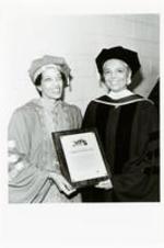 Written on verso: Spelman President Johnnetta B. Cole (left) presents honorary doctoral degree to Commencement speaker Camille Cosby. (Atlantic Civic Center, May 21, 1989). Photo: Courtesy of Spelman College.