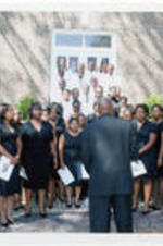 A singing group performs on the steps of Mt. Tabor A.M.E. Zion Church during the unveiling ceremony for the Coretta Scott King memorial monument.