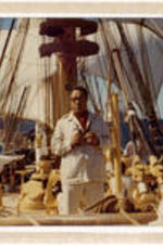 Portrait of Alex Haley on a sail ship. Written on verso: C. Eric and Lucy, with greetings of the new 1973, and with brotherly love! Alex.