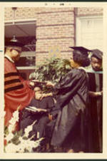 Dr. Vivian Wilson Henderson presenting a graduate with her degree at a commencement ceremony at Clark College in Atlanta, Georgia.