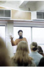 Poet Atukwei John Okai presents in a classroom.