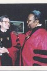 C. Eric Lincoln talks with an unidentified man after receiving an honorary degree from Boston University.