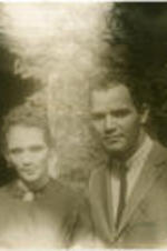 Leon Moore stands with his sister at an event celebrating the James Weldon Johnson Memorial Collection of Negro Arts and Letters at the Yale University Library. Written on verso: Leon Moore and his sister at Nora Holt's party; two singers at the James Weldon Johnson Memorial Collection of Negro Arts and Letters; founded by Carl Van vechten, in the Yale University Library; Photograph by Carl Van Vechten; 146 Central Park West; Cannot be reproduced without permission; Nov. 13, 1952.
