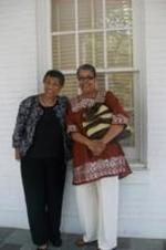 Dorothy Smith and Dr. Gloria Galyes stand outside of a building.
