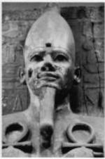 An Egyptian statue holding ankhs in both hands.