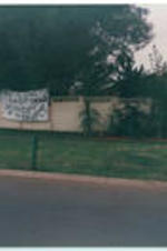 A banner hangs on the side of fence at a residence celebrating the release of Nelson Mandela from prison.