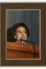 Dr. Beulah Gloster speaking at a podium.