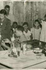 A doctor vaccinates children in an office.