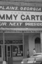 Storefront of Carter's Wholesale and a Jimmy Carter sign in Plains Georgia.