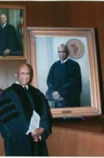Judge John H. Ruffin, Jr. stands next to his portrait. Written on verso: Portrait unveiling of former Chief Judge, the Honorable John H. Ruffin Jr. Courts of Appeals Courtroom Atlanta, Georgia September 11, 2008