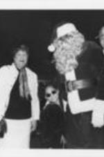 An unidentified woman, Evelyn G. Lowery, Raven-Symone, Reverend James Orange as Santa Claus, and Carolyn Watson are shown posing for a picture during a SCLC/W.O.M.E.N. Christmas party for the children of Atlanta.