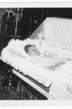 Unidentified elderly woman lies in a casket.