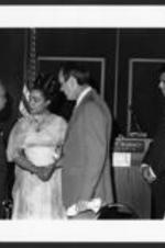 Coretta Scott King shakes the hand of an unidentified man at an event held at the Hyatt Regency.