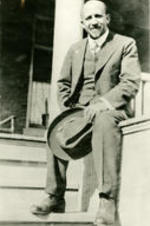 Portrait of W.E.B. Dubois sitting on a porch.