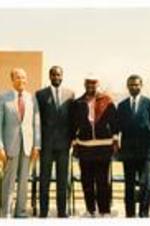 President Hugh Gloster with Edwin Moses, and unidentified persons. Written on verso: Unidentified event.