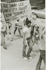 Demonstrators march in support of Tommy Lee Hines, carrying a banner that reads "Free Tommy Lee Hines! Stop Racist Klan Terror! Prisoners Solidarity Committee".