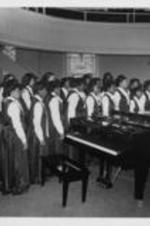 The Spelman College Glee Club performs as part of the program for the National Women's Candlelight Prayer Service. The prayer service was dedicated to the memory of Atlanta's missing and murdered children and their families. Written on verso: The Spelman College Glee Club sings before the administration of Holy Communion during the National Women's Candlelight Prayer Service for the strengthening of the family.