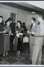 Dr. Brailsford R. Brazeal (front, right) talks with Irene Dobbs Jackson (left, Maynard Jackson's mother), Freddye Henderson (of Henderson's Travel Agency), and others at an event.