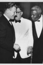 New York Governor Nelson Rockefeller is shown standing with Branch Rickey and Jackie Robinson at the Testimonial Dinner held for Robinson at the Waldorf Astoria in New York City on July 20, 1962.