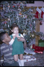David Wayne Henderson and Kimberly Anne Henderson next to Christmas tree.