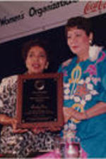 Evelyn G. Lowery is shown presenting the SCLC/WOMEN National Convener Award to Ruby Dee during the SCLC/WOMEN luncheon held as part of the proceedings for the 34th Annual Southern Christian Leadership Conference Convention in Birmingham, Alabama.