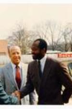 .Photograph of President Hugh Gloster and Edwin Moses shaking hands with unidentified person. Written on verso: L-R Unidentified man, Hugh Gloster &amp; Edwin Moses