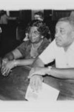 Johnnie Car and Russell Williams are shown sitting in a church pew at an event during the 23rd Annual Southern Christian Leadership Conference Convention in Cleveland, Ohio. Written on verso: Russell Williams, Johnnie Carr - Cleveland, '80