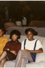 Four unidentified women sit on a couch.