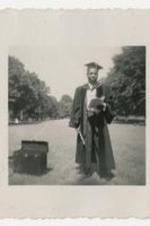 Outdoor portrait of Edward A. Jones in graduation regalia.