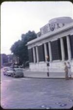 An unidentified building with columns on a street corner.
