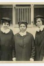 Miss Simposon, Luvenla Russel, and an unidentified woman pose outside a building.