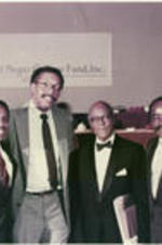 James P. Brawley at UNCF banquet. Written on verso: Taken at the UNCF Banquet during the UNCF tribute to Dr. Brawley. L to R: Clarence Cooper, Ronald Jackson, Dr. Brawley, and Carl Wise.