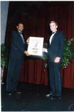Two unidentified men hold an award at the Atlanta Student Movement 20th anniversary event.