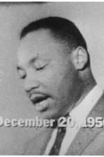 A photo of Martin Luther King, Jr. reading a statement announcing the end of the Montgomery bus boycott.