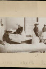 Four unidentified female nurses with bed patients.