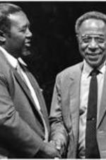 C. Eric Lincoln stands and talks with Alex Haley.