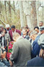 Reverend James Orange (at left, next to cameraman) is shown leading Tuskegee Mayor Johnny Ford, Joseph E. Lowery, and others in prayer during the Earl T. Shinhoster Memorial Highway marker commemoration.