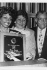 Joseph and Evelyn Lowery are shown presenting the Drum Major for Justice Award in Sports to professional golfer Renee Powell during the 12th Annual Drum Major for Justice Awards dinner. Written on verso: 4-6-91.