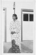 Marian Anderson stands outside. Written on verso: Marian Anderson 8/15/48