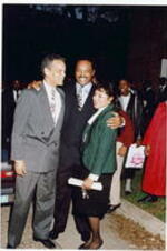 Julian Bond, Jesse Jackson, and an unidentified woman hug outside at the Atlanta Student Movement 20th anniversary event.