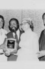 Southern Christian Leadership Conference (SCLC) President Joseph E. Lowery is shown alongside Rosa Parks and Walter E. Fauntroy presenting Fred Taylor with the Rosa Parks Award during SCLC's 23rd Annual Convention. Written on verso: Cleveland '80
