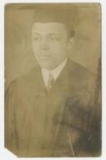 Portrait of an unidentified man wearing graduation cap and gown.