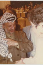 Yasser Arafat, the chairman of the Palestinian Liberation Organization, shakes hands with Evelyn G. Lowery.