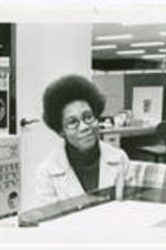 Carole Parks sits in an office and smiles.
