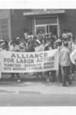 A group of people assemble and hold a sign for the March Against Repression. Written on accompanying document: March Against Repression 5-23-70 began at Ebernezer - ended Morehouse College - marchers assymbling.