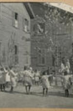 Children gather in a circle and play outside of the Leonard Street Orphan Home.