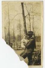 Outdoor view of James H. Touchstone with infant James A Patrick.