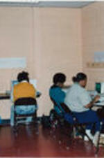 A group of women are shown working in the Computer Training Center at the SCLC/W.O.M.E.N. Learning Center.