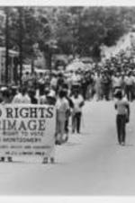 Demonstrators are shown marching down a street in Montgomery, Alabama as part of the Sacred Rights Pilgrimage March from Eufaula to Montgomery, Alabama.